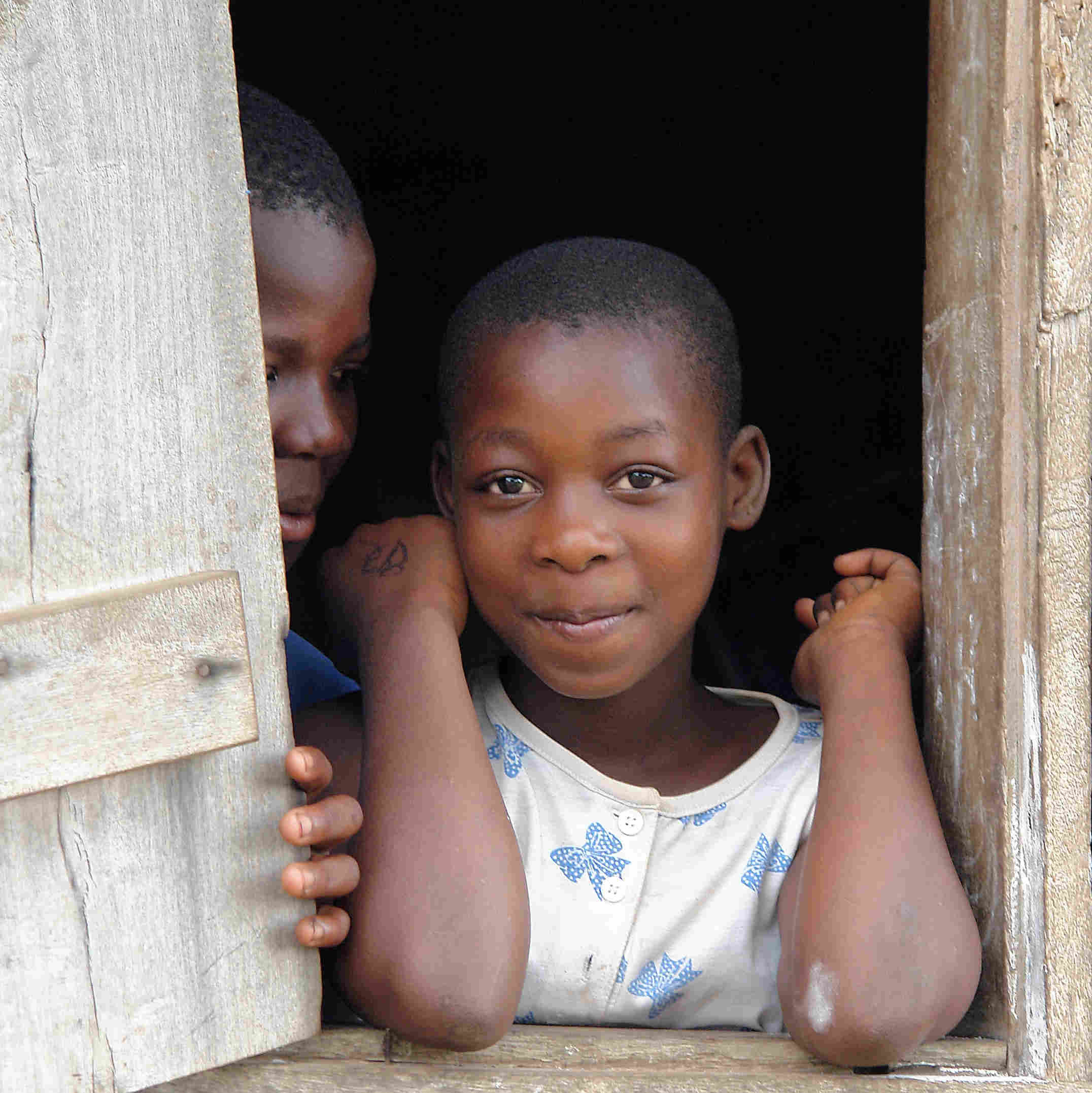 young student looking out school window